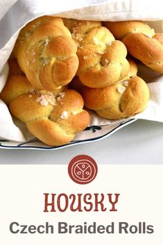 a bunch of bread rolls sitting in a bag on top of a white table cloth