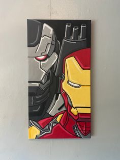 a painting of iron man and batman on a white wall next to a gray wall