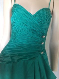 "Vtg 80s ruched teal blue hourglass cocktail, party dress XS Preowned. Condition 10/10. No issues. Small creases from storage Style A glorious teal green/blue colour. Shoe string straps Asymmetrical Ruched bodice featuring three diamanté buttons to the left front side Below the buttons the fabric falls into a drape effect. Knee length tulip style wrap over skirt.  The skirt is unlined  Fully lined bodice which is also boned with wire breast form Structured for an hourglass fit Label. Samir Size. 8 Go by measurements below. Garment laid flat  Underarm to underarm. 17\". 43cm Waist. 13\". 33cm Hips. 18\". 46cm Length from shoulder to back hem. 20.5\". 52cm My photos form an important part of the product description so please look at them and ask questions. I want you to purchase with confide Wrap Over Skirt, 1980s Style, Over Skirt, Chiffon Cocktail Dress, Dress One Shoulder, 1980s Fashion, Teal Dress, Ruched Bodice, Cocktail Party Dress