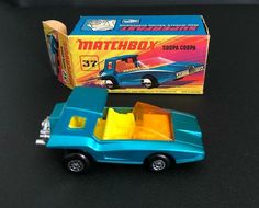 a blue toy truck next to a boxed matchbox