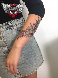 a woman's arm with a flower tattoo on the left side of her body