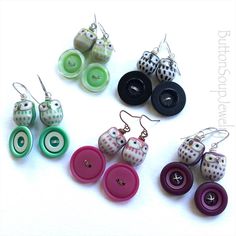 several different colored buttons and earrings on a white surface