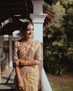 a woman in a sari standing on a porch