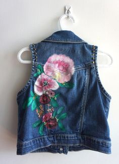 Inspired by the beautiful peony flower. This is a thrifted Gap Kids denim vest in a size L. I hand painted the floral crown on the back and added brass studs along the arms. I added three patches on the front, butterflies and a flower. All patches are reinforced with hand stitching. This vest can be machine washed on gentle or hand washed. All vests and jackets are one of a kind. Personalization is free. Painted Denim Vest, Kids Denim Jacket, Hand Painted Denim Jacket, Kids Jackets, Painted Denim Jacket, Painted Jacket, Bridal Jacket, Painted Denim, Custom Jacket