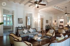 a living room filled with furniture and a ceiling fan