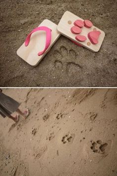 there is a dog paw print on the sand next to a spatula with pink hearts