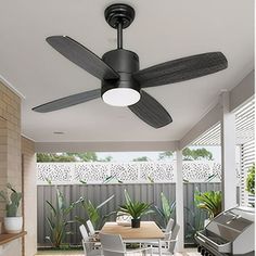 a ceiling fan is hanging from the ceiling in an outdoor living room with white furniture