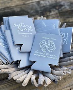 five blue notebooks sitting on top of driftwood next to each other with writing on them