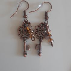 Beautiful Handcrafted Skeleton Key Earrings With 3 Sm Dangle Beads. Victorian/Reinassance Steampunk/Cosplay Steampunk Brown Jewelry For Gifts, Steampunk Brown Jewelry Gift, Steampunk Brown Jewelry For Gift, Brown Steampunk Jewelry Gift, Handmade Brown Steampunk Jewelry, Handmade Vintage Copper Beaded Earrings, Handmade Steampunk Gold Earrings, Handmade Adjustable Steampunk Earrings, Handmade Gold Steampunk Earrings