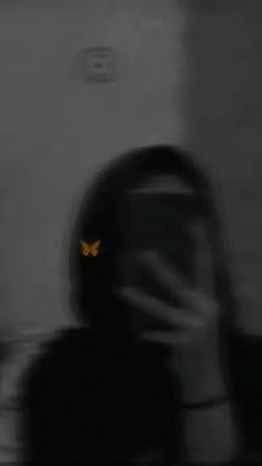 a blurry image of a person with a butterfly on their face in the dark