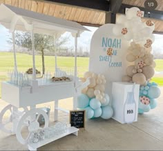 an ice cream cart decorated with balloons and cookies