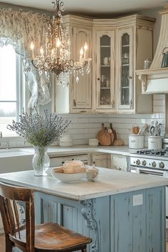 a kitchen with an island and chandelier hanging from the ceiling