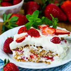 a piece of cake on a plate with strawberries