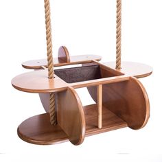 a wooden table with two swings attached to it