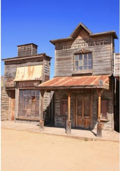 an old western town with two wooden buildings