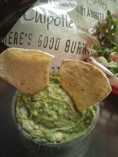 guacamole and tortilla chips in a plastic cup