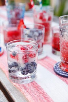 red, white and blue drinks on a picnic table