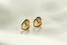 Open heart-shaped earrings, handmade with 18k yellow gold. Simplicity at its best, these classic studs are light enough to wear comfortably, but solid -- made with real, 18k gold -- a quality generally reserved for more expensive pieces. If you have a question, please send a message ... I'm always happy to help! These earrings were handcrafted with love in Los Angeles, California. Elegant Heart Detail Earrings For Gift, Elegant Earrings With Heart Detail, Elegant Heart Shaped Everyday Earrings, Elegant Heart-shaped Everyday Earrings, Elegant Open Heart Earrings For Everyday, Elegant Everyday Heart Shaped Earrings, Minimalist Pierced Yellow Gold Heart Earrings, Elegant Hypoallergenic Heart Earrings For Everyday, Elegant Hypoallergenic Everyday Heart Earrings