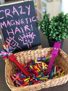 a basket full of crayons and a sign that says crazy magnetic hair sticks