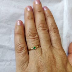 **KINDLY CHECK OUT THE VIDEO OF THE ITEM FOR A CLEARER VIEW**Details of the ring Gem: Emerald Gem shape and size: Round, 3 mm Gem weight: 0.08 carats Gold purity: 14K (58.33% approx.) Gold weight: 1.14 gms total weight of ring:1.16 gms Natural Emerald cut set in solid 14K yellow gold. The Gold purity is guaranteed and it comes with authentic 14 kt gold hallmark. Since these Rings are handmade, Size Customization is available for this ring and it is available in all ring sizes. Gemstone customiza Diamond Ring With Gemstone For May Birthstone Gift, Round Cut Emerald Ring As Gift, Dainty Round Cut Emerald Ring As Gift, Gift Emerald Diamond Ring With Bezel Setting, 14k Gold Emerald Birthstone Ring For Gift, 14k Gold May Birthstone Ring Gift, Emerald Diamond Ring With Bezel Setting Gift, May Birthstone Ring With Prong Setting Gift, May Birthstone Ring Gift With Prong Setting