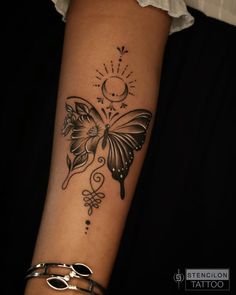 a woman's arm with a butterfly tattoo on it