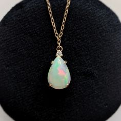 No stone is more mythical or enchanting than the opal. This necklace is a great way to get a clean and modern look while honoring a beautiful stone and style. We showcase this unique and captivating stone in a handcrafted setting, topped with a sparkling diamond. Available in 14k yellow gold Features a natural 13mm x 9mm opal, approx. 2.50ct Accented by a 2mm natural diamond Pendant measures approx. 16mm x 9mm Hanging from a new 18" 14k chain with secure lobster clasp Pear-shaped Opal Jewelry For Formal Occasions, Formal Opal Pear-shaped Jewelry, Formal Pear-shaped Opal Jewelry, Elegant Drop Opal Jewelry, White Pear-shaped Opal Jewelry, Elegant Pear-shaped Opal Jewelry, Yellow Gold Opal Teardrop Pendant Jewelry, Opal Drop Gemstone Jewelry, Pear-shaped Opal Gemstone Jewelry