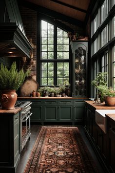 a kitchen filled with lots of green cabinets and counter top space next to a window