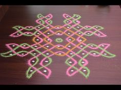 a wooden table topped with an intricately designed rangdil on top of it