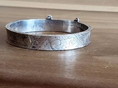 This is a vintage, sterling silver bracelet. It is signed GIFA It is hinged at one side and has a safety on the other. It is marked 925 and has tested positive for sterling. This piece will come to you with insurance. This measures 7 inches around on the inside. It is a bit under .5 inches wide. Don't forget to stop in at my other Etsy shop... http://www.etsy.com/shop/xtdesigns. Follow me on Twitter at... MyYiayiaHadThat@MyYiayiaHadThat. If you have a wish list or are looking for something speci Vintage Adjustable Sterling Silver Bracelet Stamped 925, Vintage Adjustable Sterling Silver Bracelet, Vintage Etched Sterling Silver Bangle Bracelet, Antique Engraved White Gold Bracelets, Etched Sterling Silver Bangle Bracelet Vintage Style, Adjustable Vintage Bracelets Stamped 925, Sterling Silver Round Stamped Bracelet, Adjustable Vintage Stamped 925 Bracelets, Vintage Engraved White Gold Bracelets