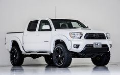 a white toyota truck parked in a room