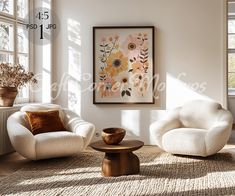 a living room with two white chairs and a coffee table in front of a window