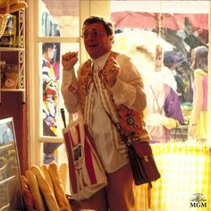 a man is standing in front of some bread