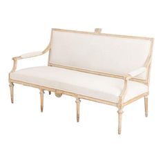 a white couch sitting on top of a wooden frame