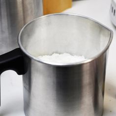 a stainless steel pot sitting on top of a white counter