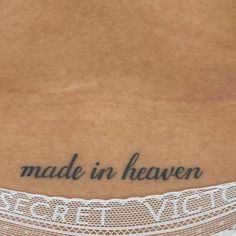 a woman's stomach with the words made in heaven written on her lower back