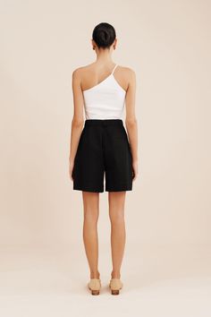 The wear-everywhere Wesley Shorts have a bermuda style, relaxed silhouette. They're cut from 100% cotton and are pleated just below the flattering high-rise waist. High waisted style Double hook and bar opening Concealed centre front fly zip Internal adjustable waistband Belt loops Front pleats Side seam pockets Functional back welt pockets Material: 100% Cotton Made in a BSCI and WRAP certified factory Chic Short Tops For Daywear, Classic Shorts For Summer Day Out, Chic Cotton Bermuda Shorts For Day Out, Chic Black Bermuda Shorts For Summer, Chic Relaxed Fit Bermuda Shorts For Day Out, Classic Bermuda Shorts With Built-in Shorts For Summer, Classic High-waisted Bermuda Shorts For Summer, Chic Bermuda Shorts With Short Inseam For Summer, Chic Summer Bermuda Shorts With Short Inseam