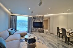 a living room filled with furniture and a flat screen tv sitting on top of a wall