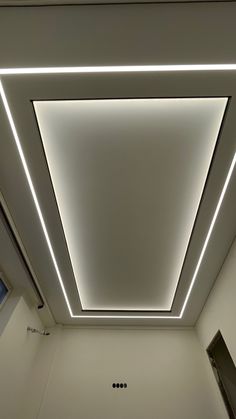 the ceiling in this bathroom is lit up with white lights and recessed light fixtures