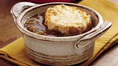 a pot filled with soup sitting on top of a wooden table