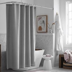 a bath room with a toilet and a shower curtain