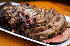 sliced meat sitting on top of a white plate