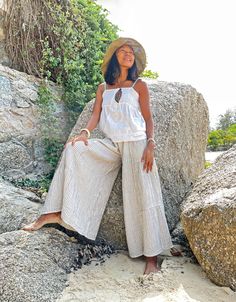 "Wide Leg Pants, White Summer Pants, Boho Pants Beautiful flare pants made with very soft double gauze cotton with stripe pattern Sizing: Made in one size to fit XS to XL / US: 2/4/6/8/10/12/14/16 Measurement; Elastic waist 23\"- 48\" Hip max 50\" Rise 11.5\" Length outseam 36\" Length inseam 24\" **Model is a size US 6. 5'4\" Tall** Description: Made with 100% soft double gauze cotton. The fabric is super soft and has a black stripe pattern. Medium-thick, breathable, and not a see-through. Elas Baggy Summer Bottoms For Beach, Baggy Beach Bottoms For Beach Season, Summer Beach Pants With Baggy Fit, Baggy Wide Leg Pants With Elastic Waistband For Beach, Baggy Summer Vacation Bottoms, Baggy Bottoms For Vacation, Baggy Wide Leg Beach Trousers, Baggy Wide Leg Pants For Beach, Relaxed Fit Ankle-length Harem Pants For Vacation