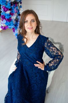 a woman in a blue dress posing for the camera