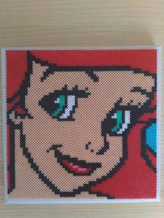 a cross stitch picture of a woman's face with blue eyes and green eyes