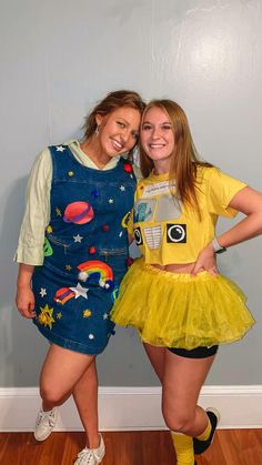 two girls dressed in costumes posing for the camera