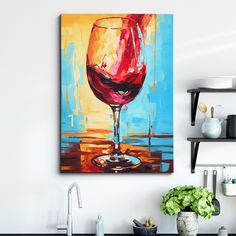 a painting of a glass of red wine on a wall above a kitchen sink and counter