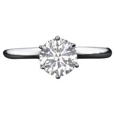 a round brilliant cut diamond ring on a black band, with the center stone in white gold