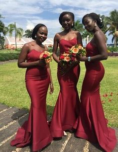 three women in red dresses standing next to each other