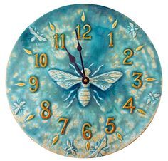 a blue clock with a yellow and white bee on it's face, surrounded by numbers