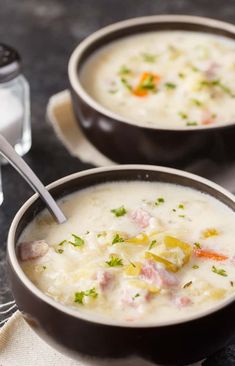 two bowls filled with soup on top of a table